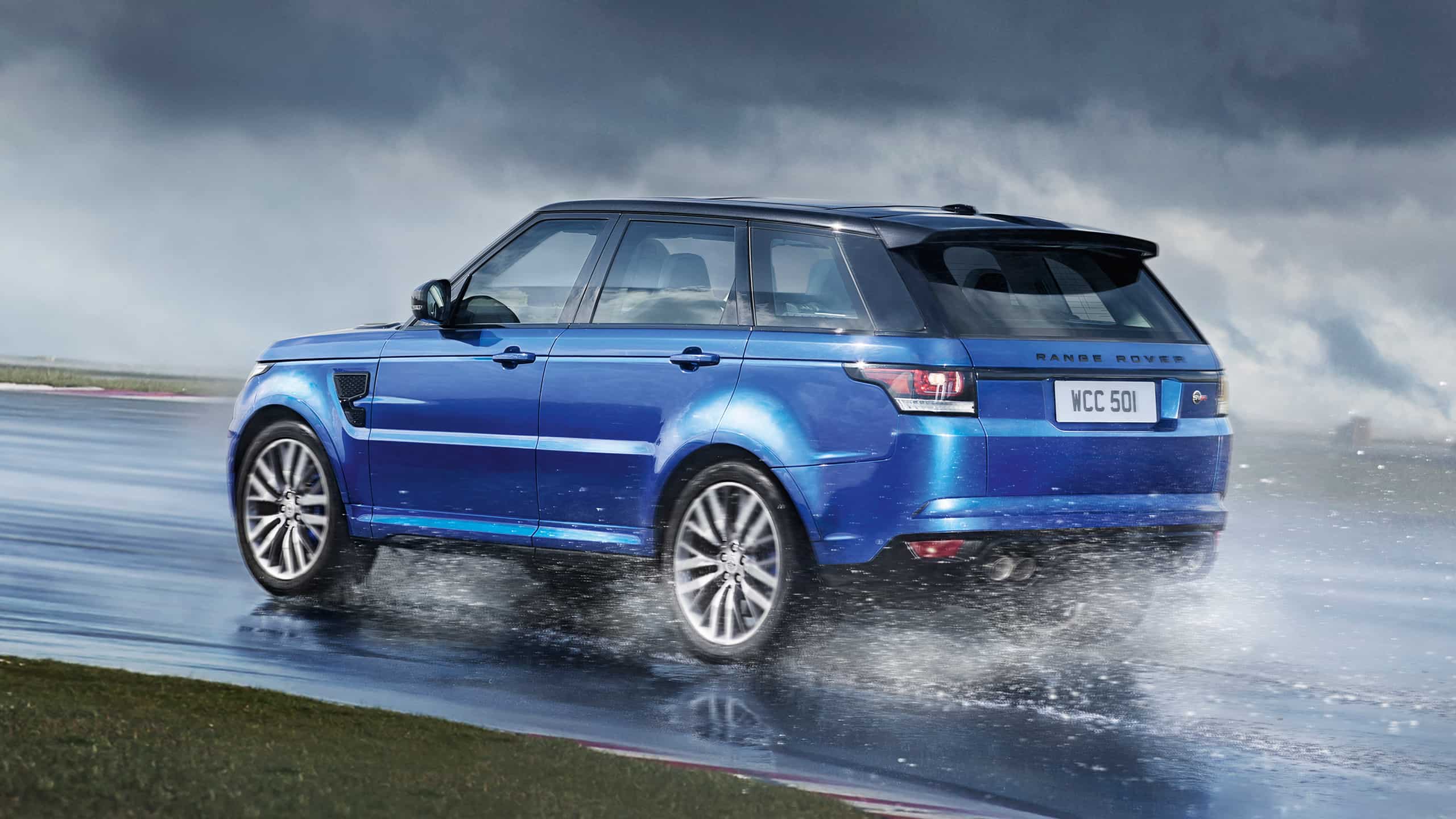 Range Rover Sport driving quickly through water on road