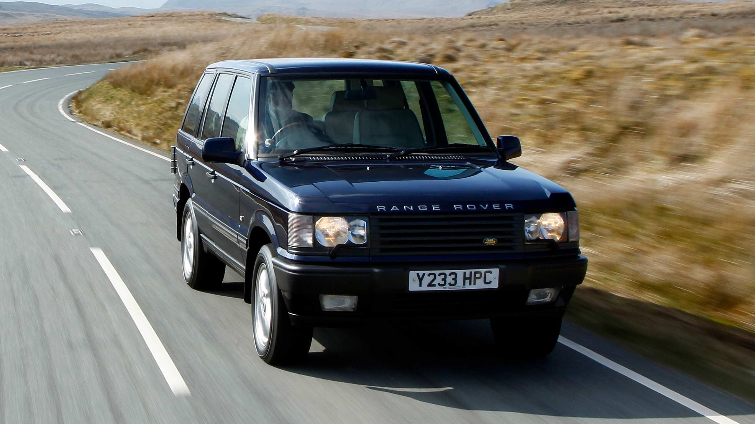 Range Rover Moving on Hilly Terrain Road
